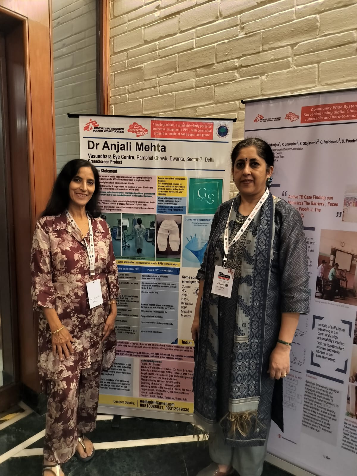 Dr. Anjali Mehta standing beside GreenScreen innovation posters